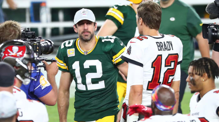 Aaron Rodgers and Tom Brady meet on field.